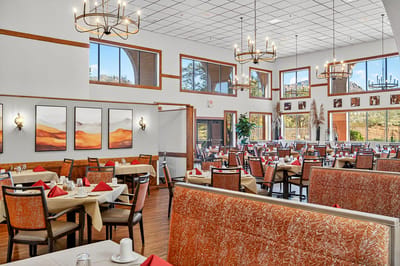 Bright dining room with large windows and elegant decor