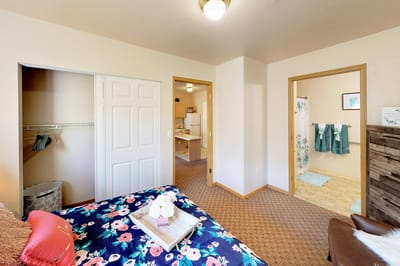 Interior view of a resident bedroom with floral bedding