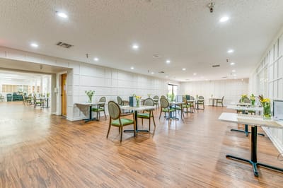 Bright dining room with tables and chairs arranged
