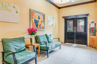 Bright lobby area with green seating and artwork