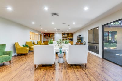 Bright common area with seating and bookshelves