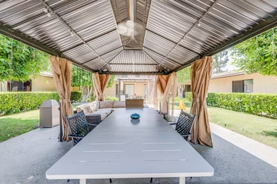 Covered outdoor seating area with table and chairs