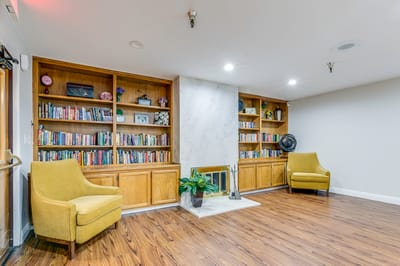 Interior view of a cozy common area with bookshelves