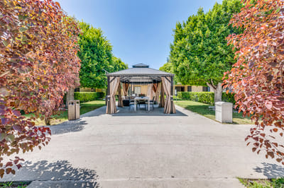 Outdoor gazebo surrounded by trees in a senior living facility