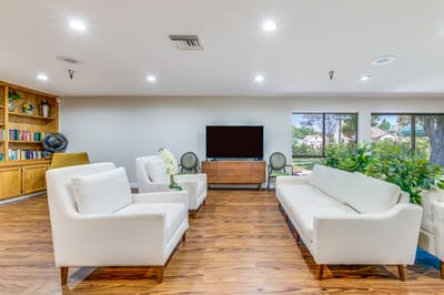 Bright common area with seating and bookshelves