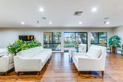 Bright common area with seating and large windows