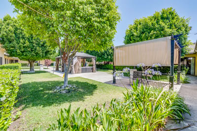 Outdoor seating and shade structure in a garden area