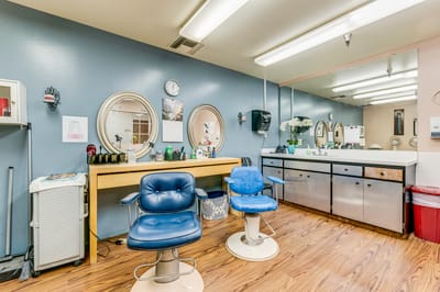 Interior view of a beauty salon area with chairs and mirrors