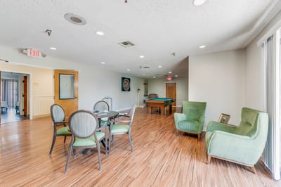 Interior of a common area with seating and a pool table