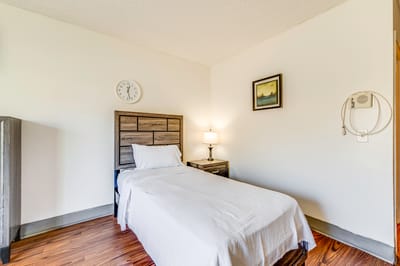 Simple resident room with a bed and lamp