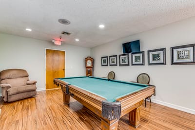 Interior game room with pool table and seating