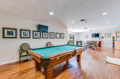 Interior view of a billiards room with a pool table