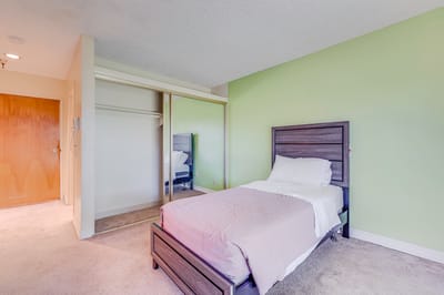 A private resident room with a bed and green wall