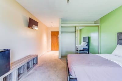 Private resident room with a bed and TV