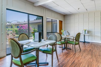 Dining area with tables and views of outdoor flowers