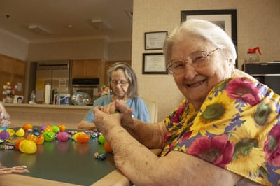 Residents engaged in a group activity with colorful eggs.