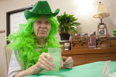 Resident celebrating with festive green attire.