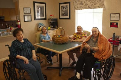 Residents engaged in an activity with a basket.