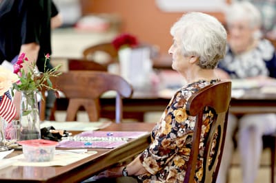 Resident participating in an activity at a dining table