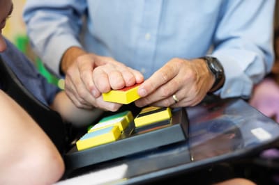 Two hands engaged in a tactile activity.