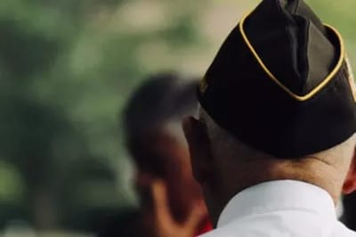 Rear view of an elderly man in a hat