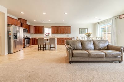 Interior common area with a couch and kitchen