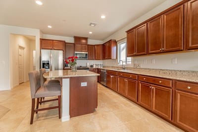Modern kitchen with wooden cabinets and bar seating