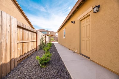 Side pathway alongside a residential building.