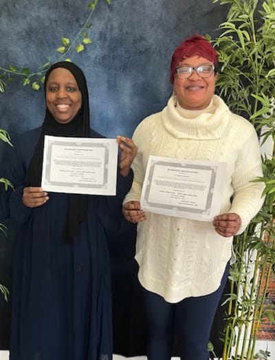 True Care Home Care – Bronx, home care in Bronx, NY — Two women holding certificates in front of a backdrop