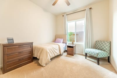 Cozy single resident room with a bed and natural light.