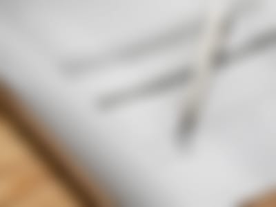 Blurred abstract image of a notebook and pen.