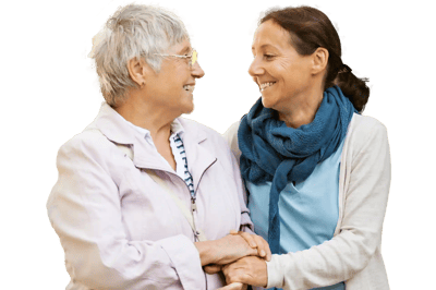 Two women smiling and holding hands.