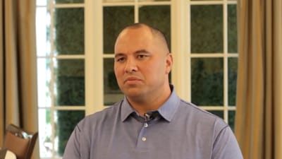 A man in a collared shirt, indoors.
