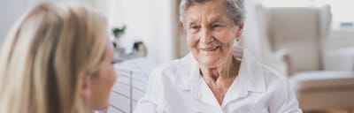 Elderly woman smiling during conversation