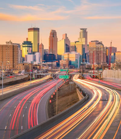 City skyline with light trails from vehicles