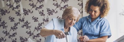Caregiver assisting resident with an activity