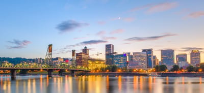 City skyline with a bridge at sunset