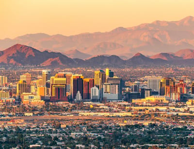 City skyline with mountains at sunset