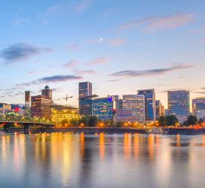 City skyline at sunset over the water