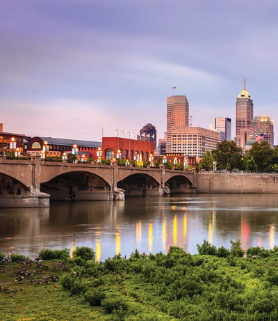 Cityscape view with a river and bridge.