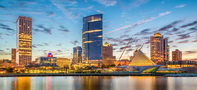 City skyline at sunset with modern buildings.