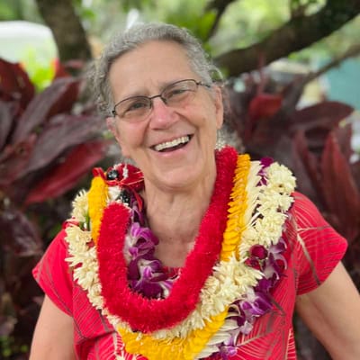 Smiling woman wearing a lei.