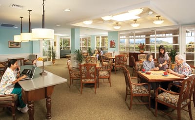 Residents and staff interact in a common area.