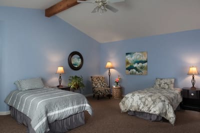 Brightly furnished resident room with two beds