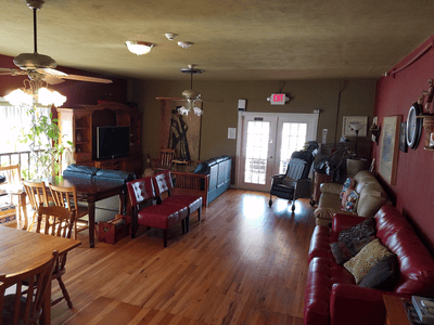 Bright common area with seating and wooden floors