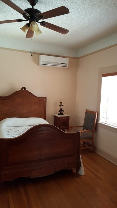 Cozy bedroom with a wooden bed and a rocking chair
