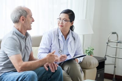 Doctor consulting with a senior resident in a bright room.