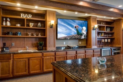 Interior view of a bar area with shelves and TV