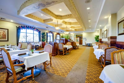Dining area with elegantly decorated tables and chairs