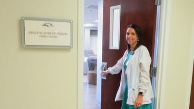 Staff member in front of the family room door